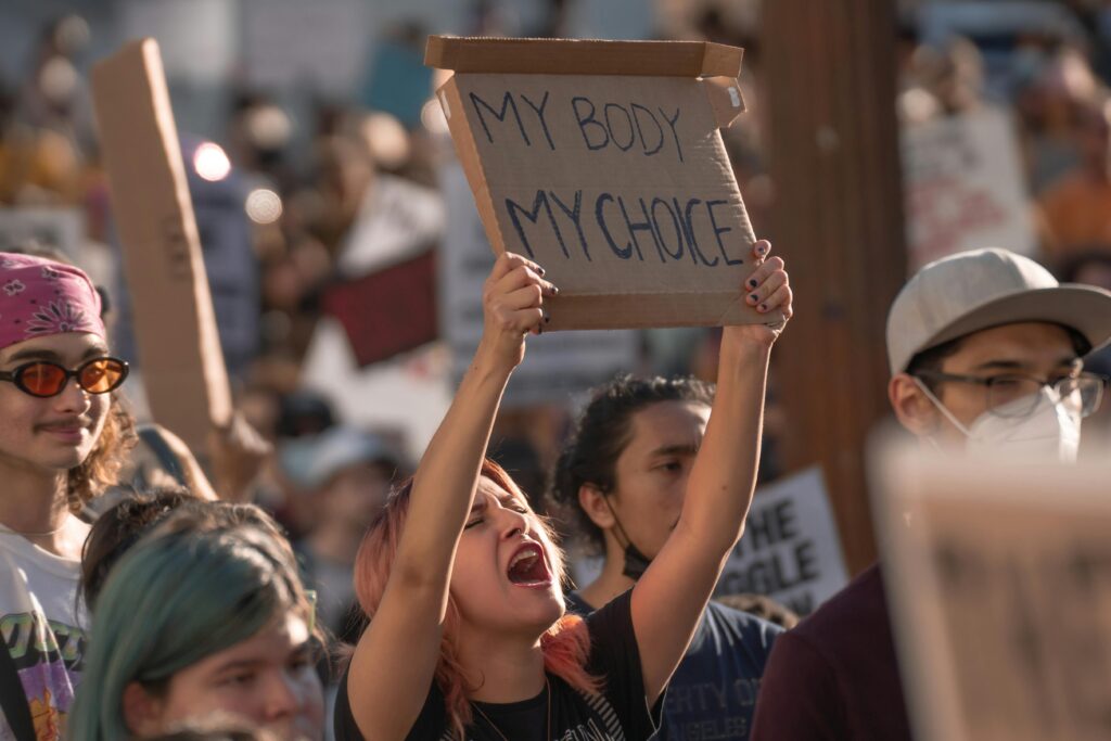 Woman holding "My body, my choice" poster